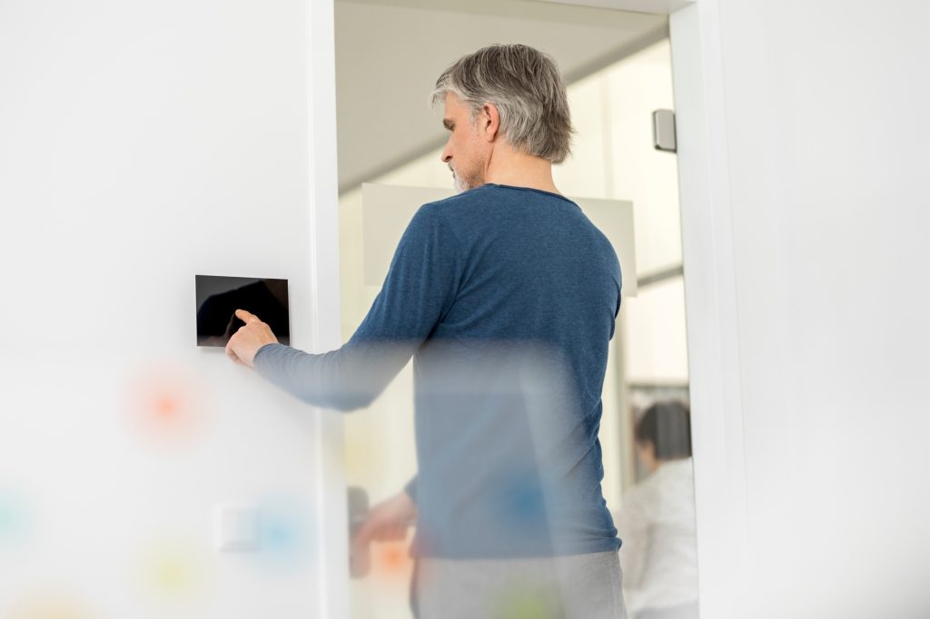 Businessman in office with telecontrol